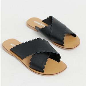 Black scalloped slip on sandals